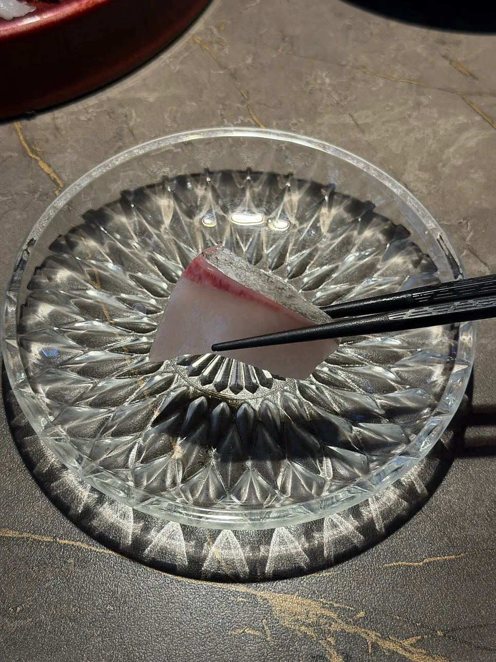 A piece of aged olive flounder sashimi