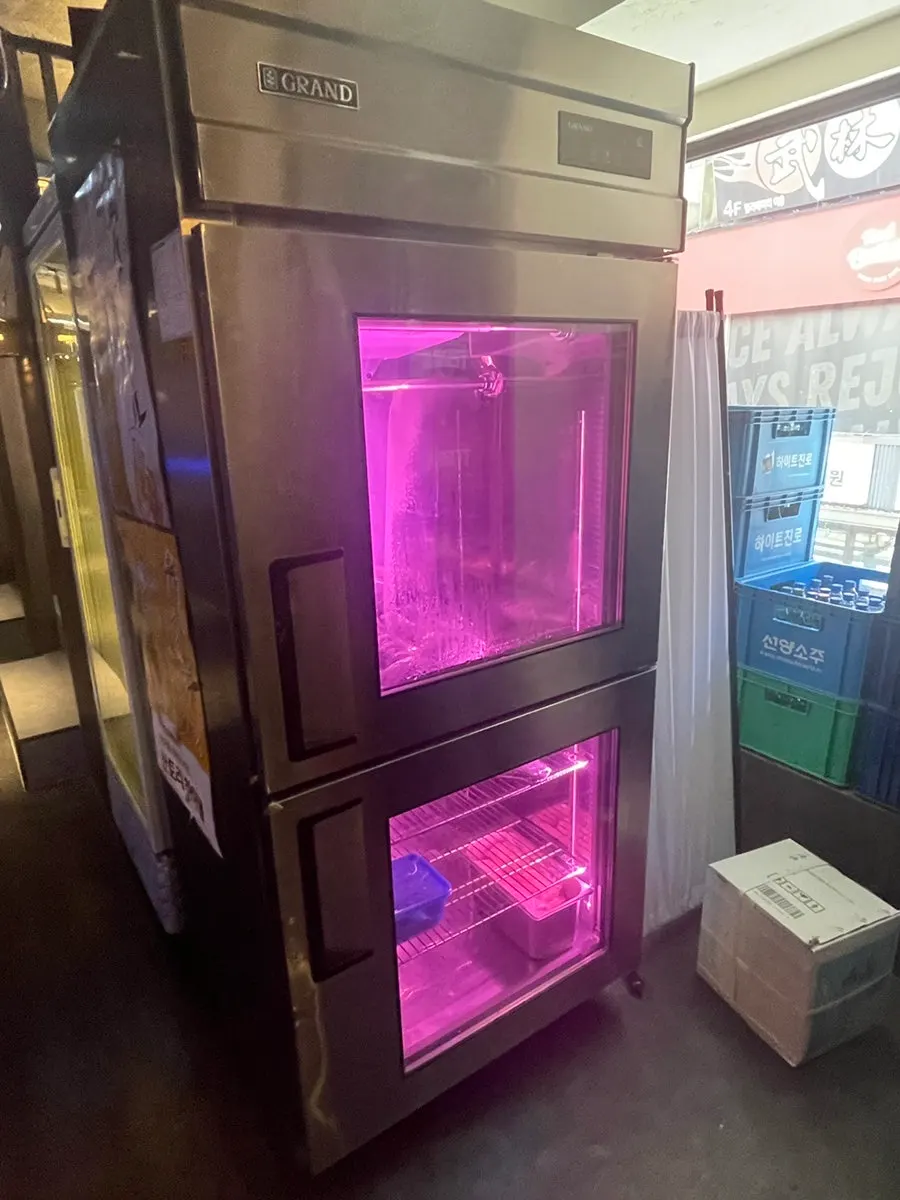 Pink-lit aging fridge at the 3rd floor entrance