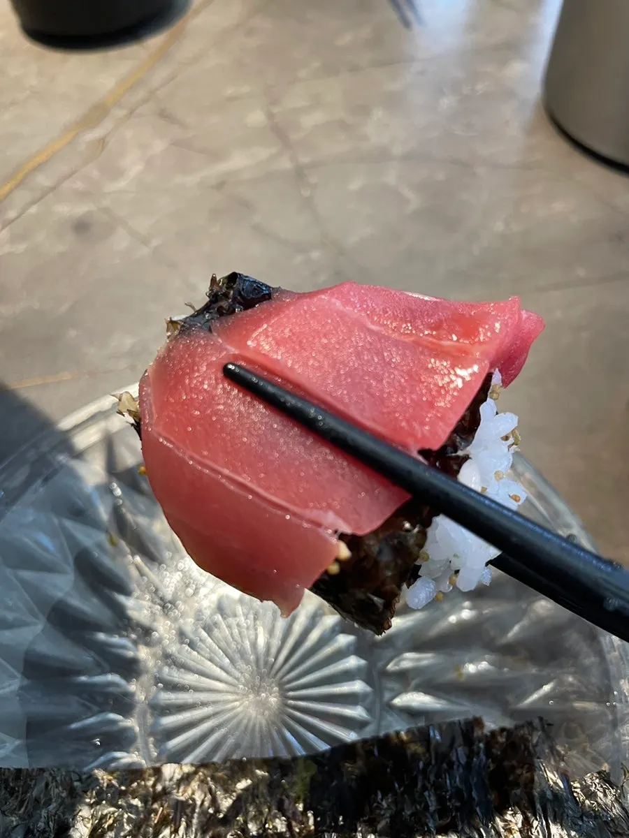 A piece of sashimi topped with black roe