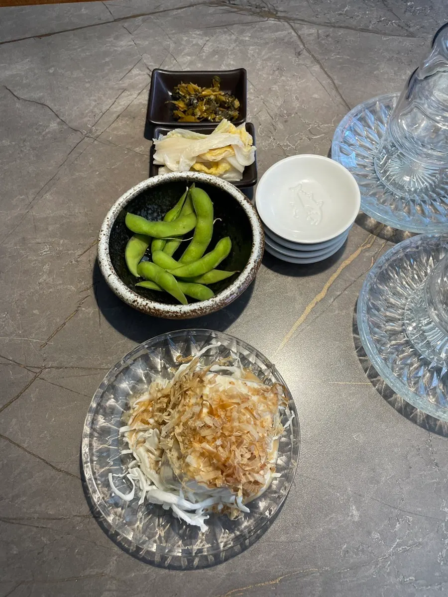 A thick piece of sashimi held with chopsticks