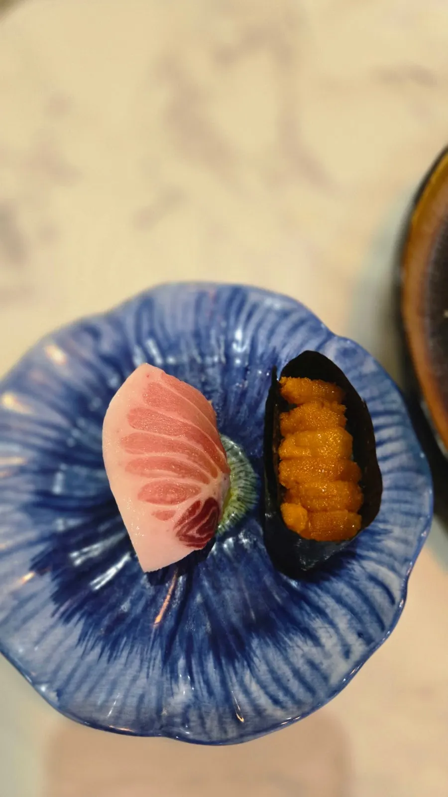 Additional tuna belly sushi and sea urchin roe sushi ordered on the side