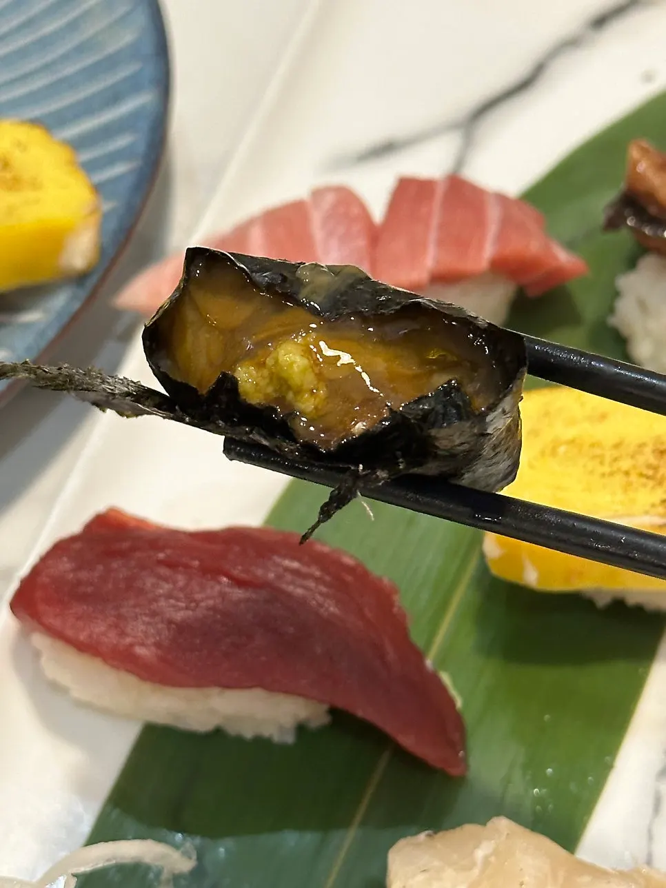 A piece of sushi with a thick cut of fish