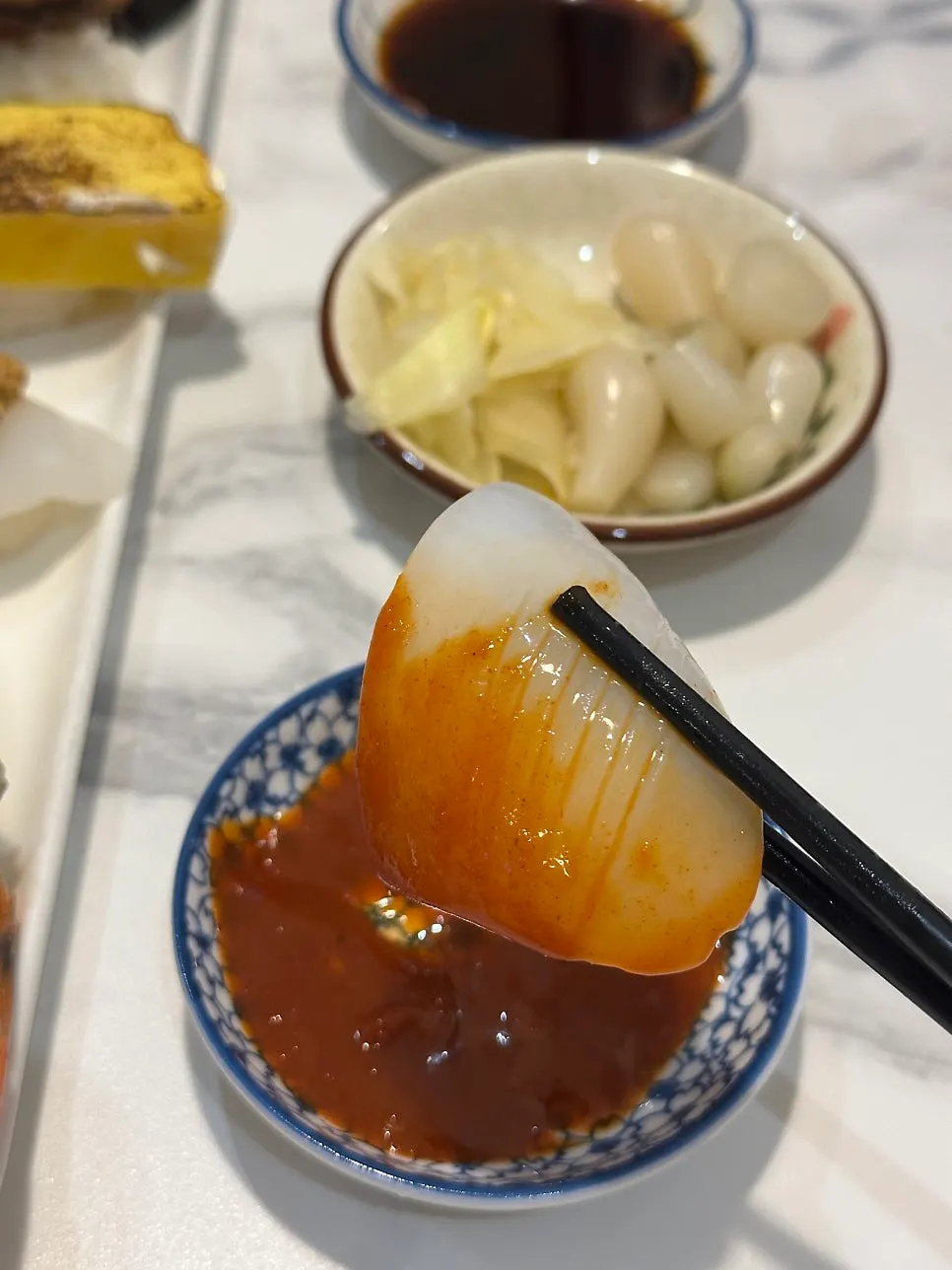 Cuttlefish sashimi with a small bottle of sake