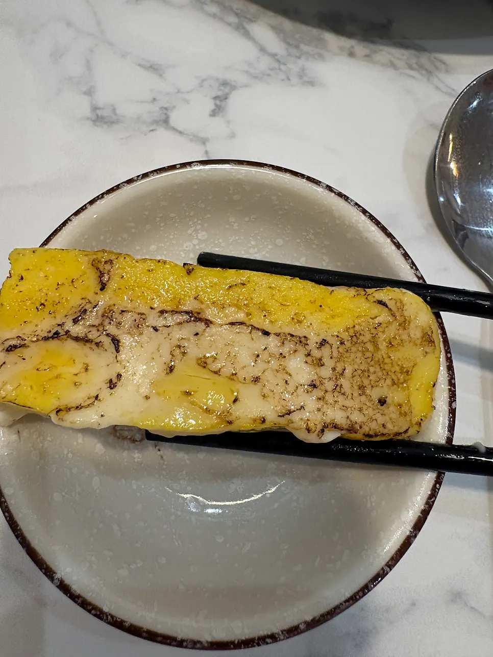 Egg sushi lightly seared with sauce