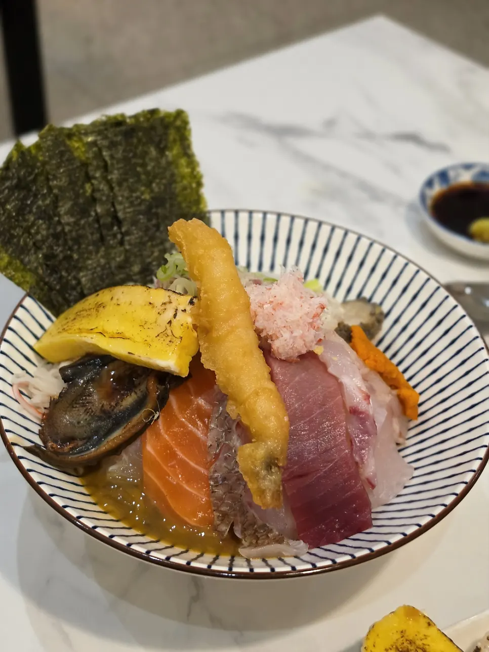 Seaweed sheets served alongside the kaisendon