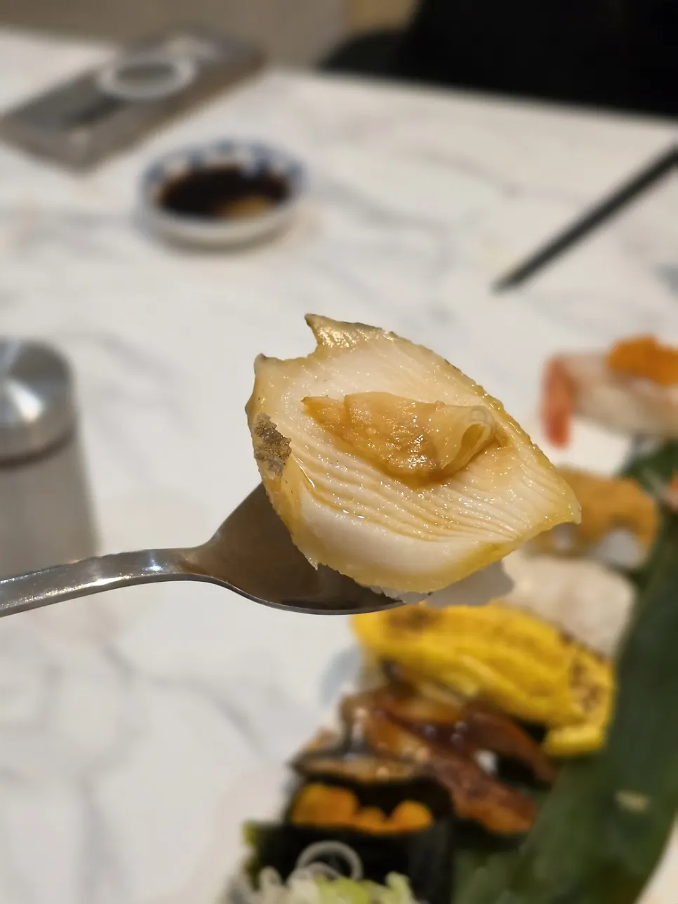 Abalone sushi topped with ginger