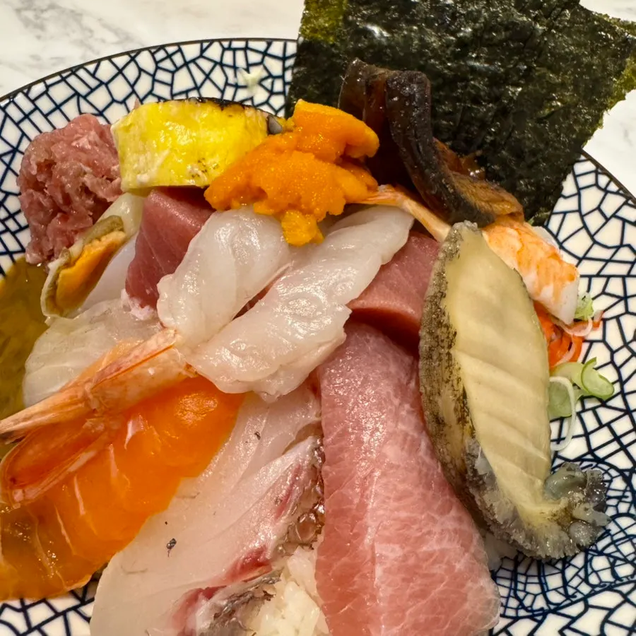 Close-up of kaisendon with uni and abalone