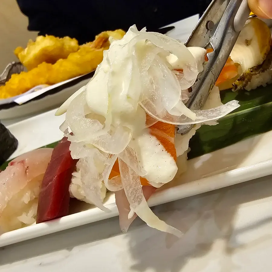 Picking up a piece of egg sushi