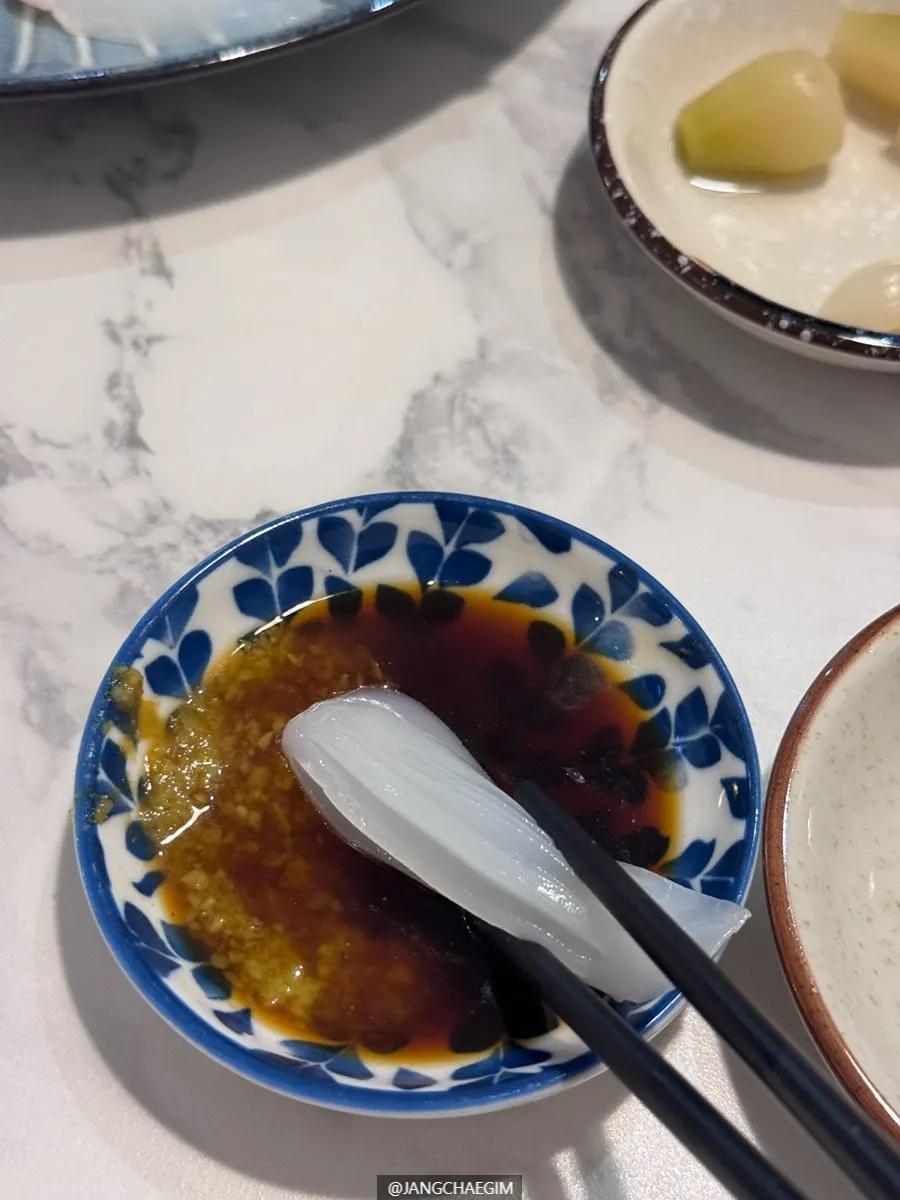 A piece of sashimi with wasabi