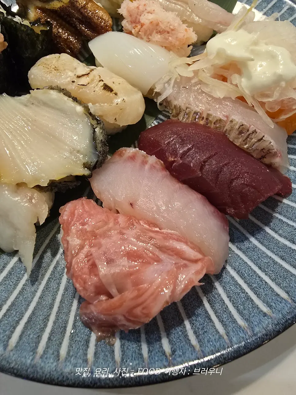 A piece of sushi topped with aged fish