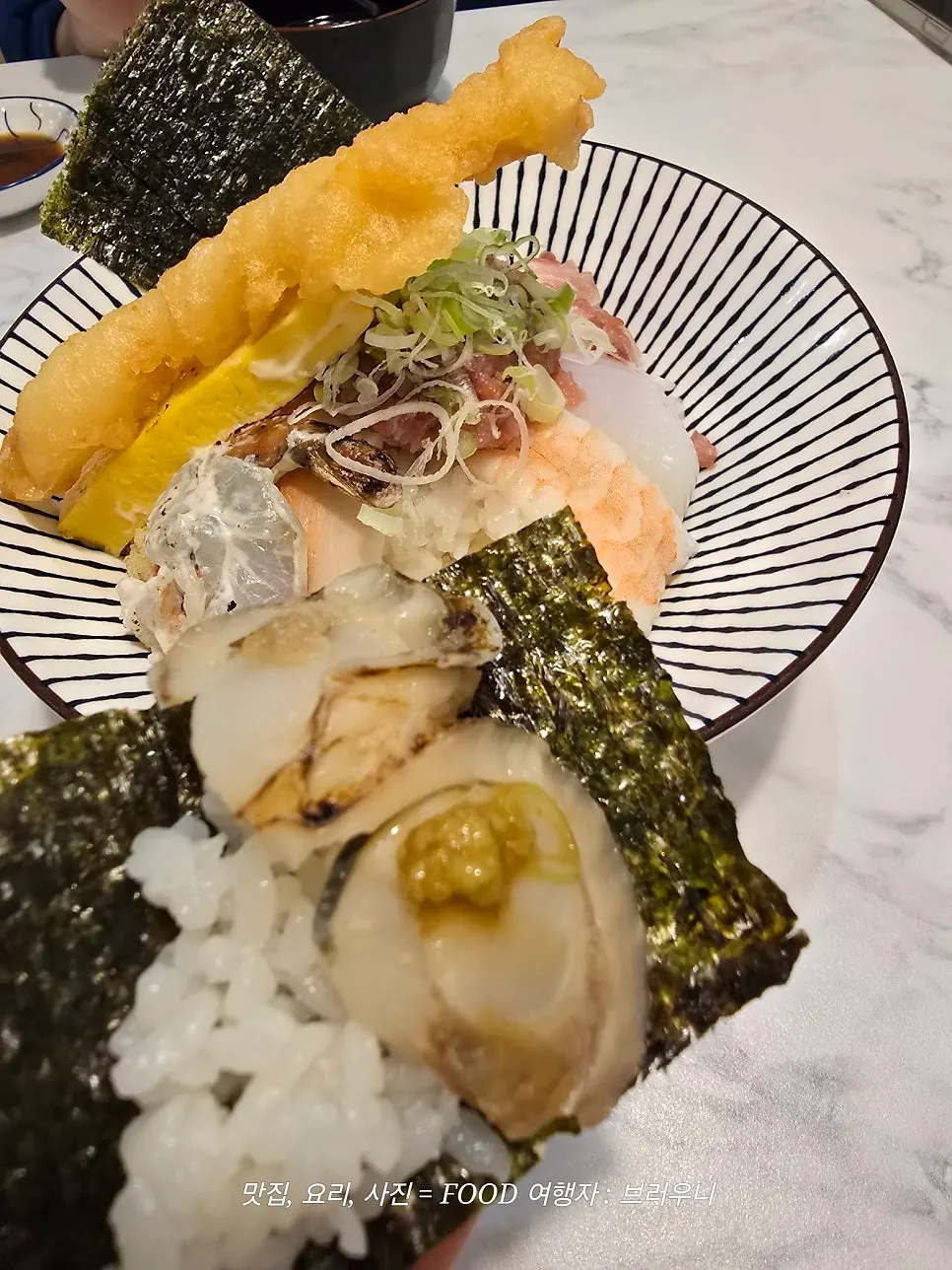 Kaisendon topped with fish, egg, and fried shrimp