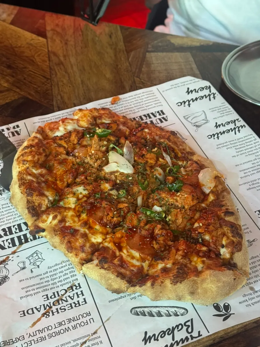 Vertical cut of the handmade-dough Didi's Buldak Pizza