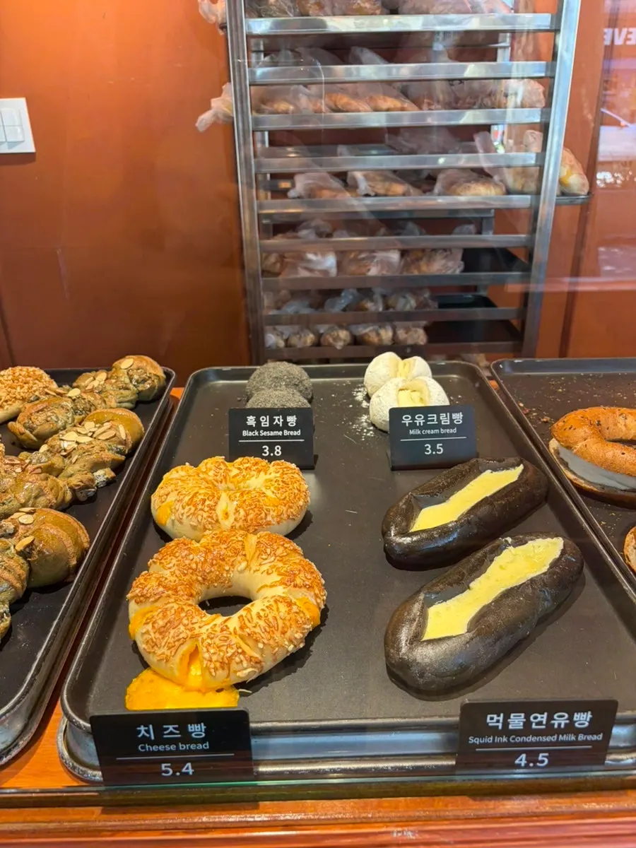 Injeolmi bread, peanut bread, and other breads on display at Munhwa Bakery