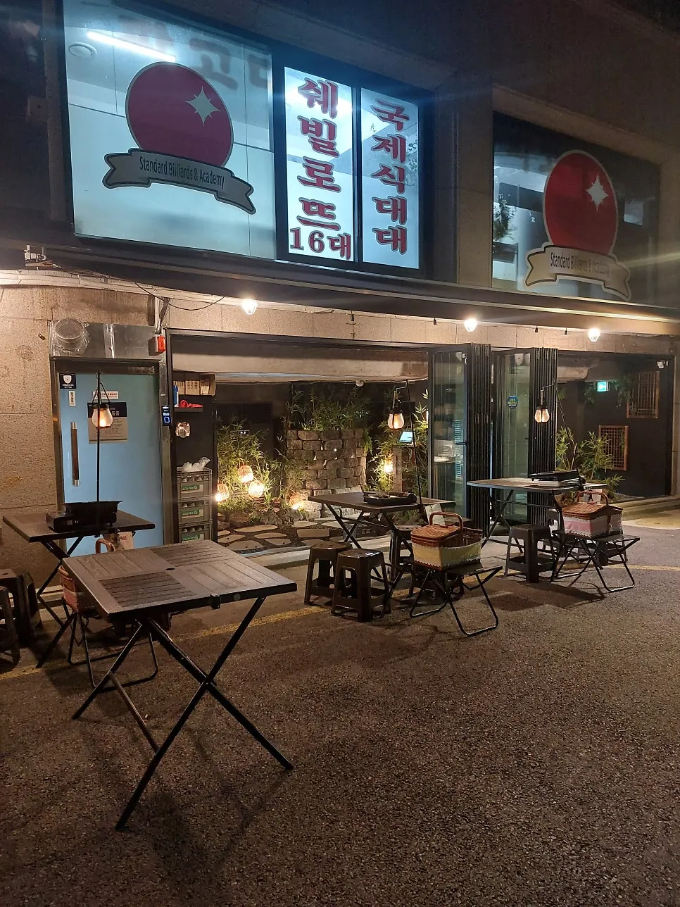 Outdoor seating lit up along the stone-wall alley
