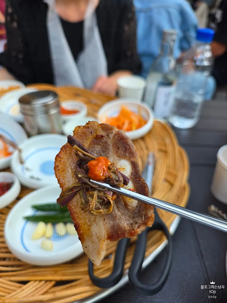 Flash-frozen pork belly being grilled with pepper