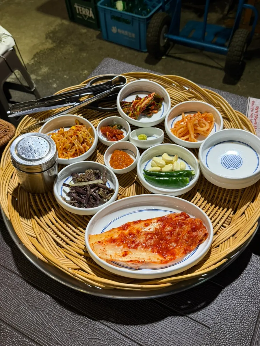 Banchan side dishes served with frozen pork belly