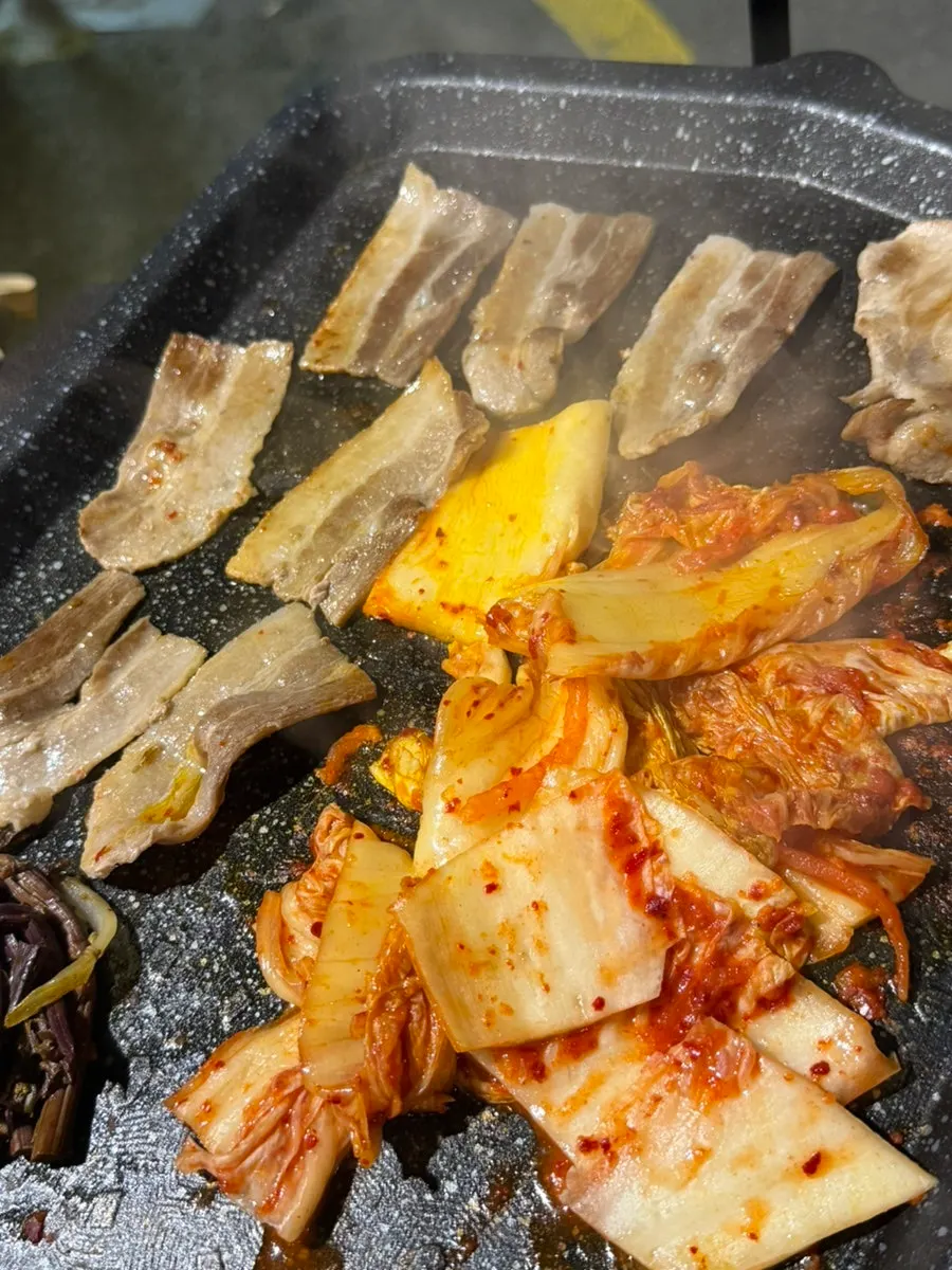 Thin pork belly slices cooking quickly on the grill