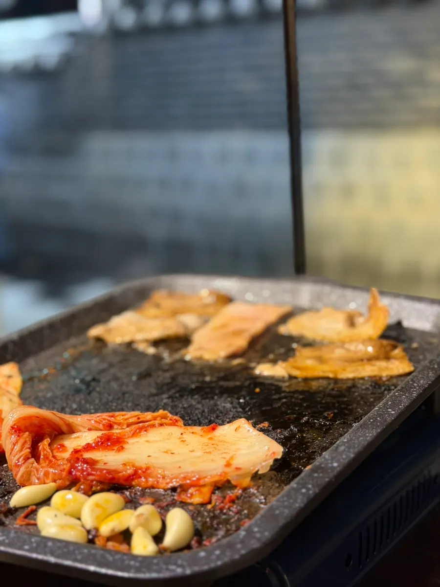 Enjoying frozen pork belly at an outdoor table