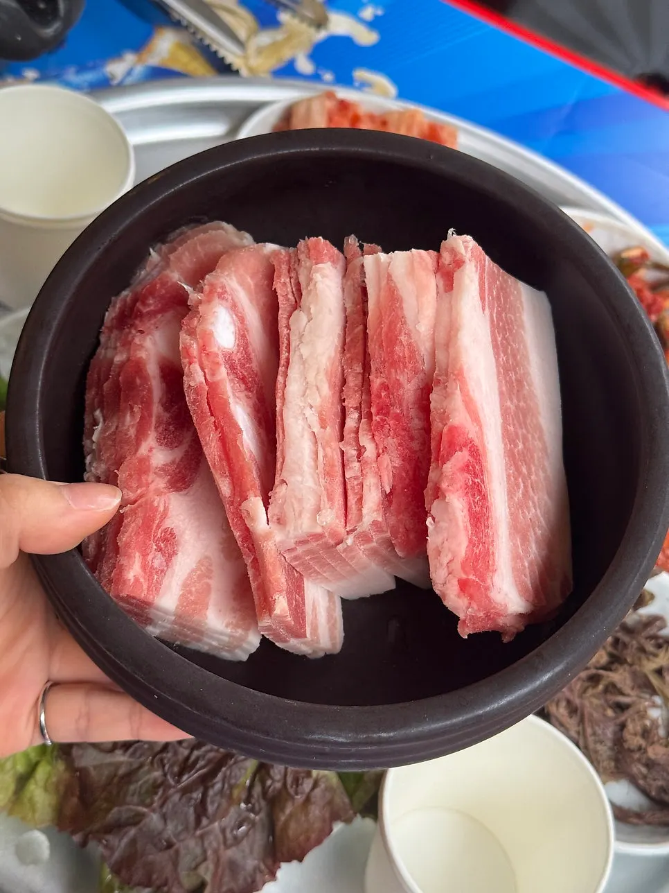 Frozen pork belly slices before hitting the grill