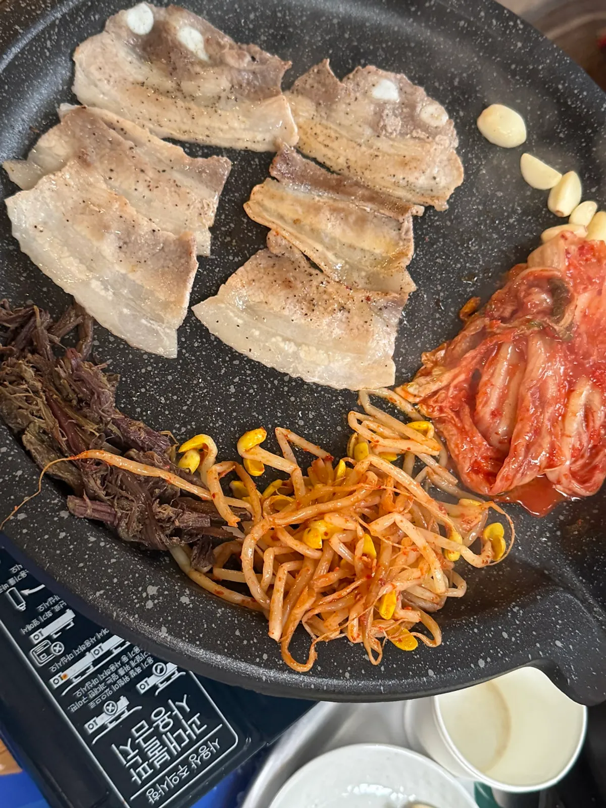 Jongno naengsam on the grill at Chowon Restaurant's outdoor tent