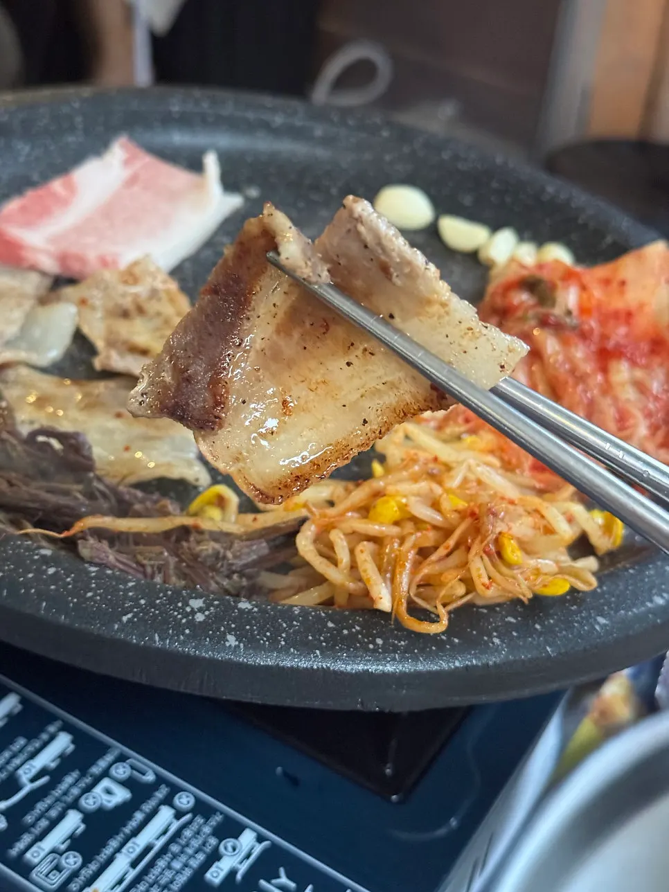 A grilled piece of naengsam served with side dishes