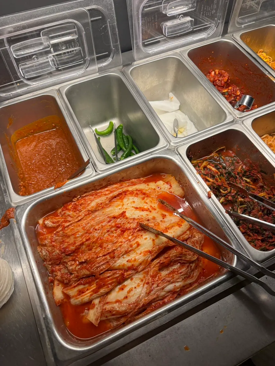 Self-serve bar corner with ssamjang, garlic, and other sides