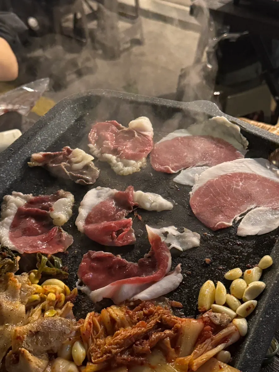 Thin slices of chadolbagi cooking on the grill
