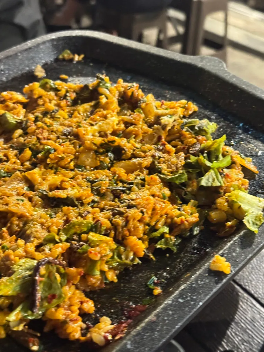Close-up of fried rice with a soft-yolk egg on top