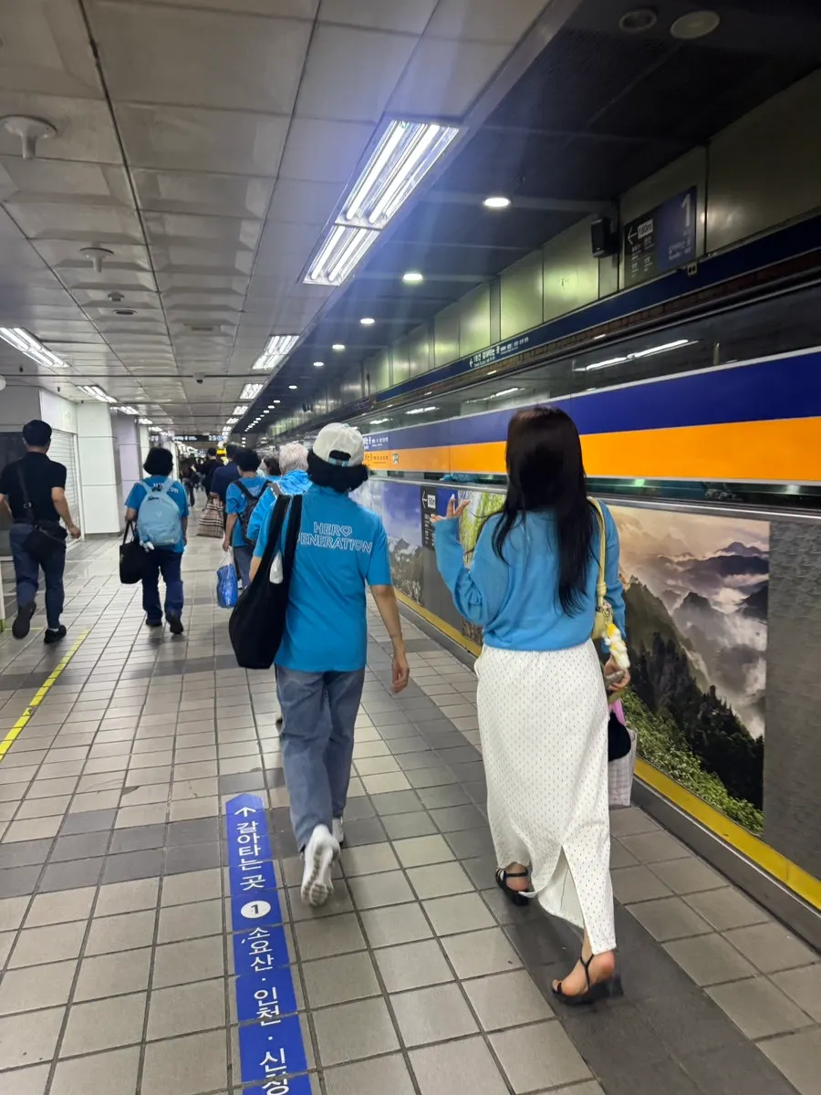 Friends in matching t-shirts walking through Jongno streets