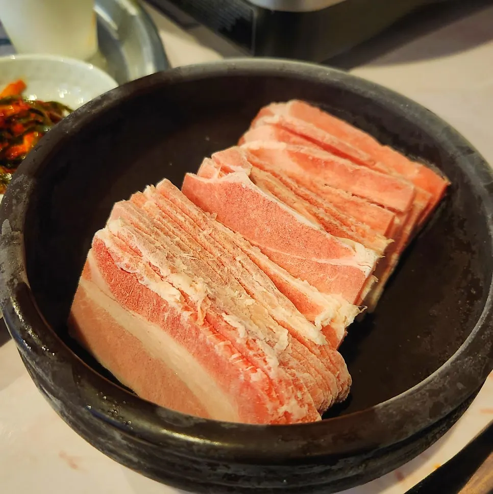 Thinly sliced frozen pork belly served in a jar