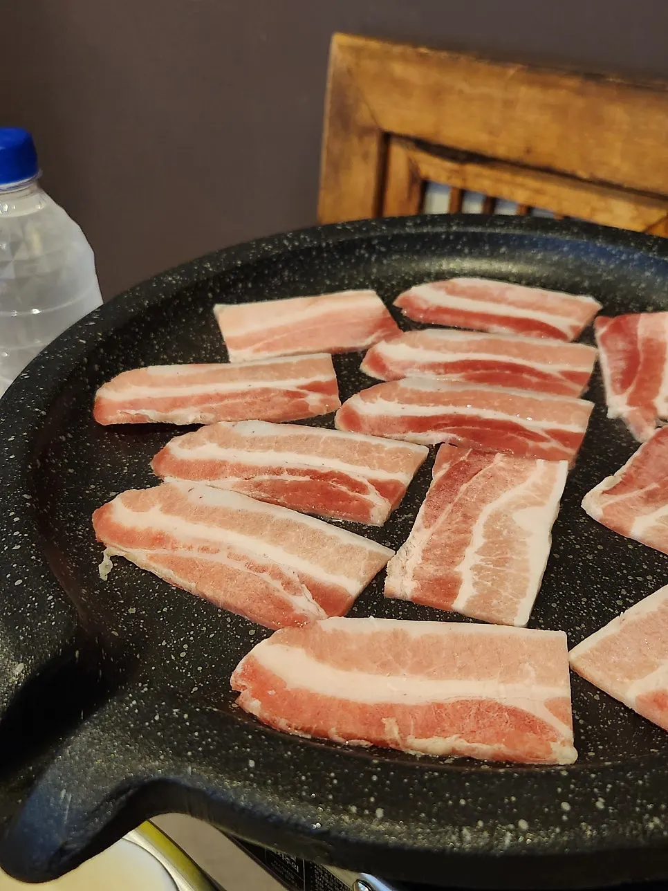 Frozen pork belly placed on the grill