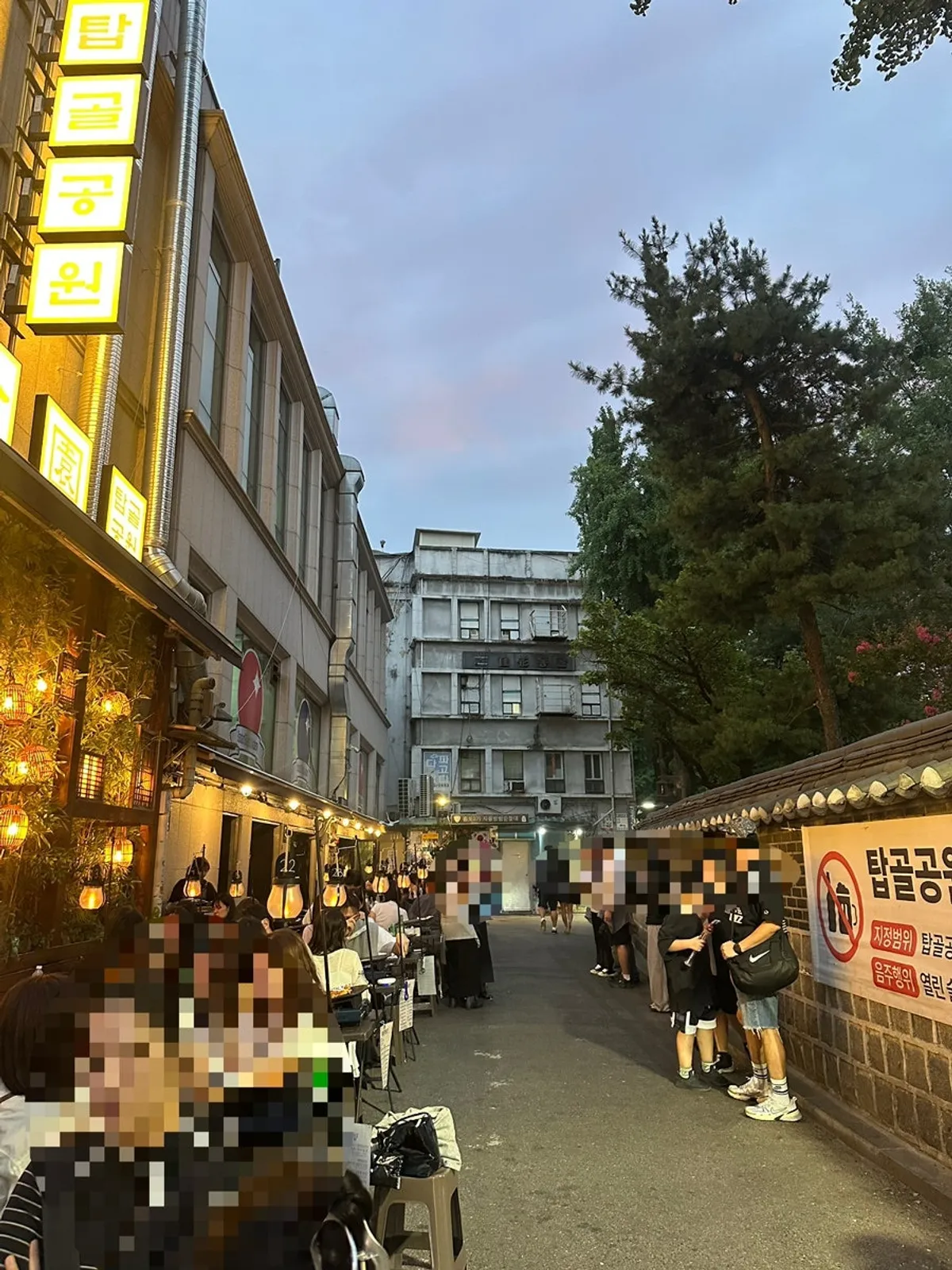 Outdoor BBQ table atmosphere along the Jongno 3-ga stone wall path
