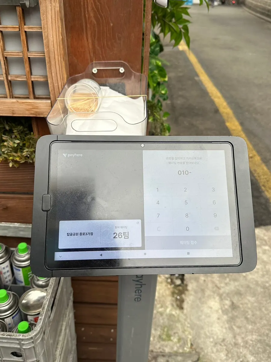 Waiting registration machine in front of the store with the outdoor BBQ alley direction shown