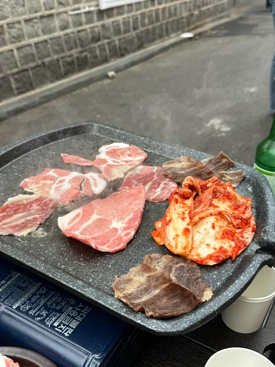 Table setup with three servings of frozen pork belly, pork neck, and brisket