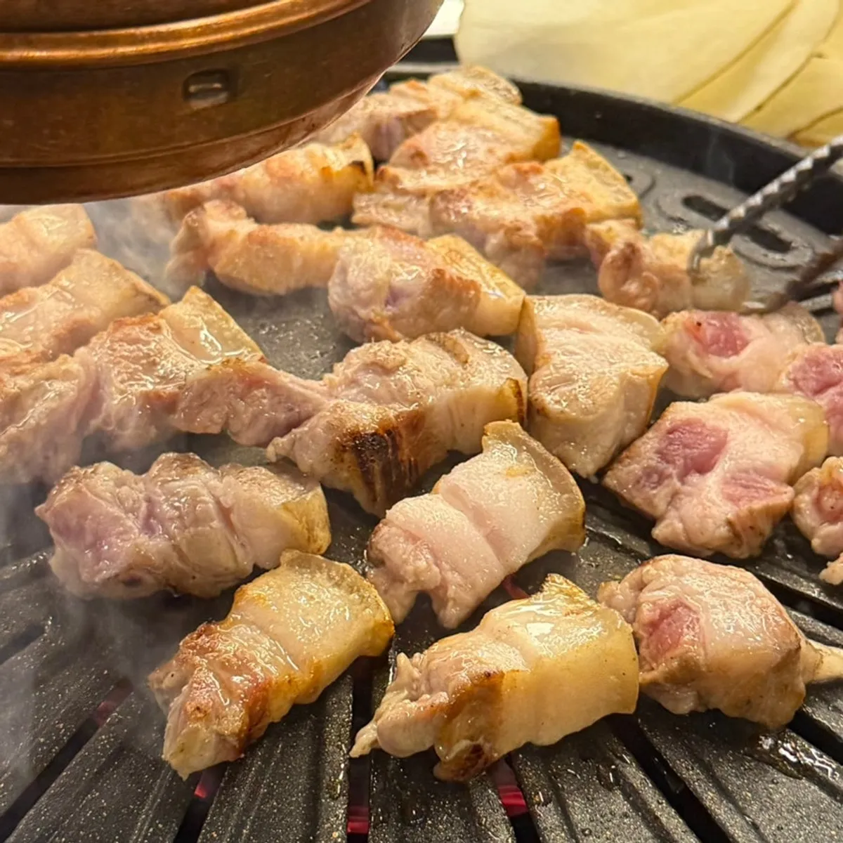 Staff grilling black pork o-gyeopsal