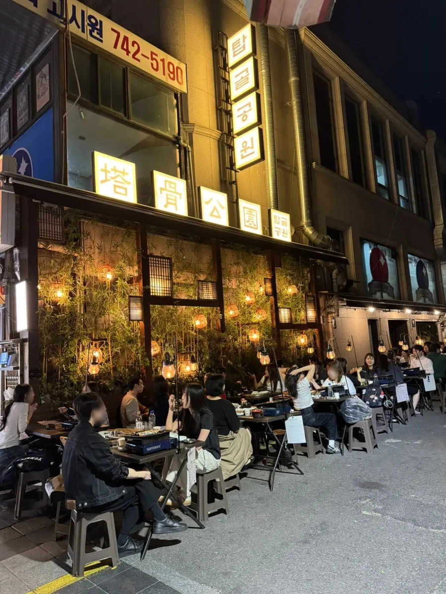 Illuminated outdoor seating at the Jongno 3-ga BBQ spot