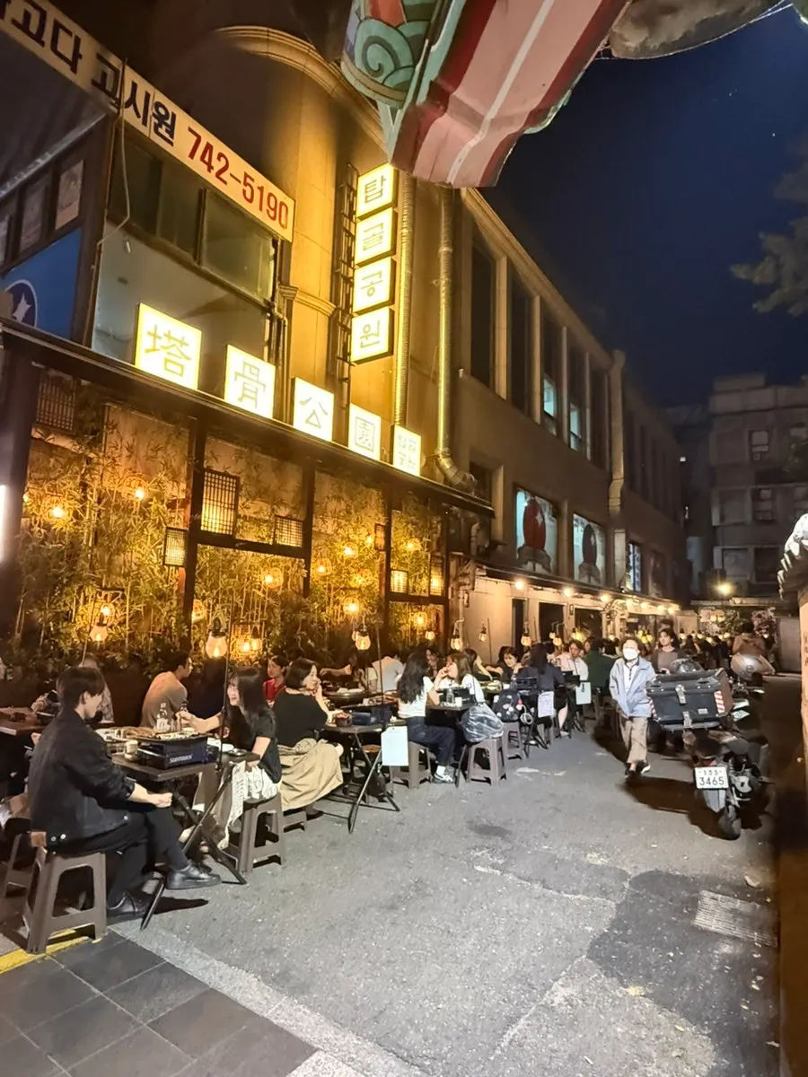 Wide view of outdoor tables packed with customers