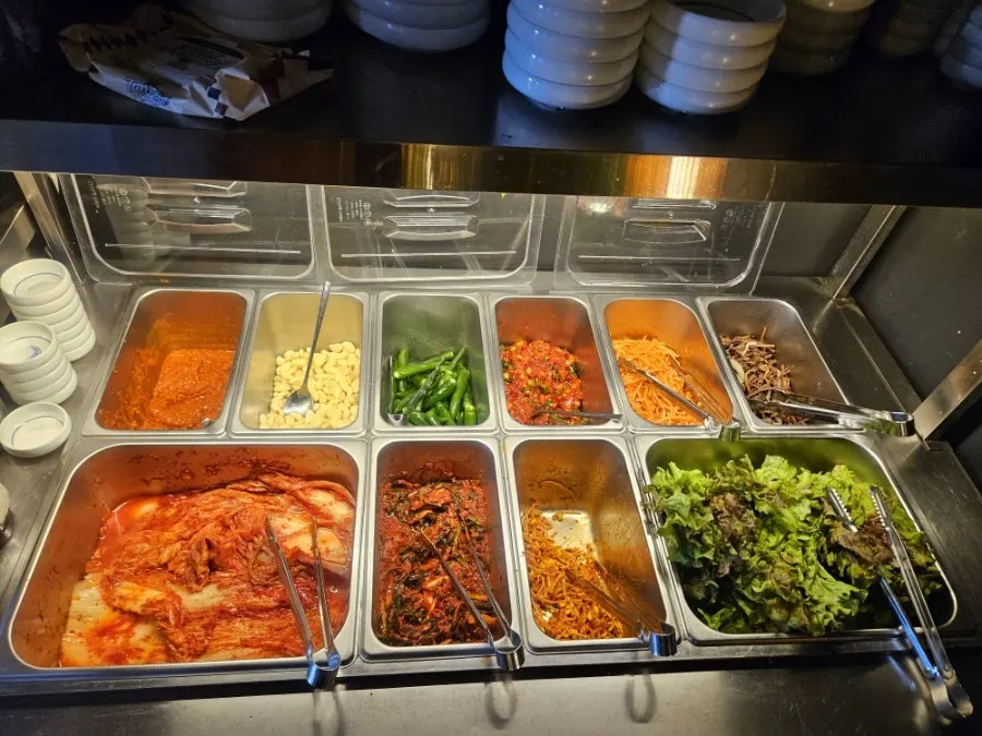 Plates of green onion kimchi and salted fermented squid