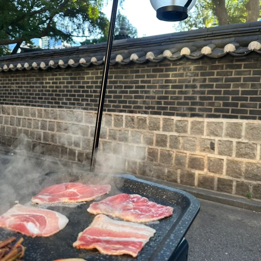 Grill with pork belly and pork neck cooking together