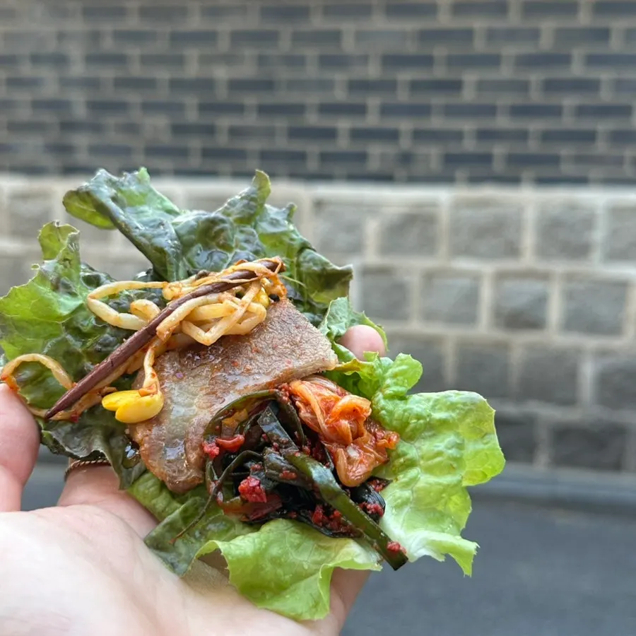Lettuce wrap topped with kimchi and scallion kimchi
