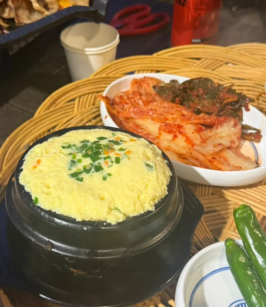 Frozen pork belly and side dishes on the grill