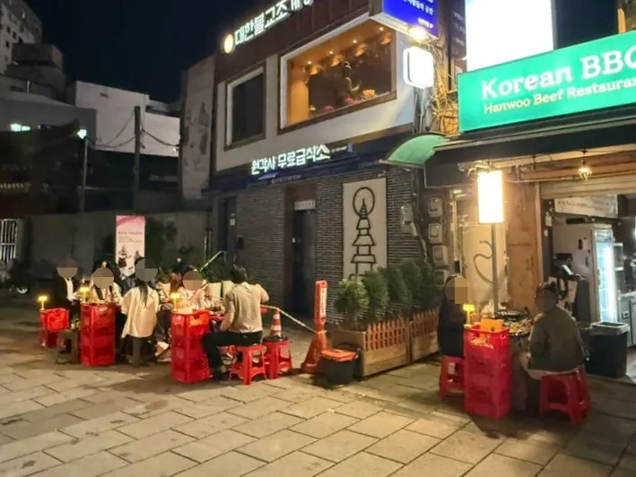 Fully seated outdoor tables on the Jongno 3-ga dining street