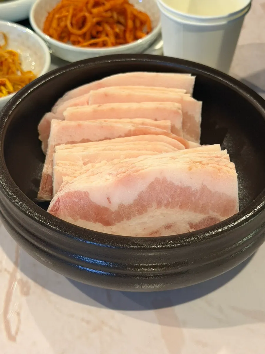 Frozen pork belly served in a jar-shaped container