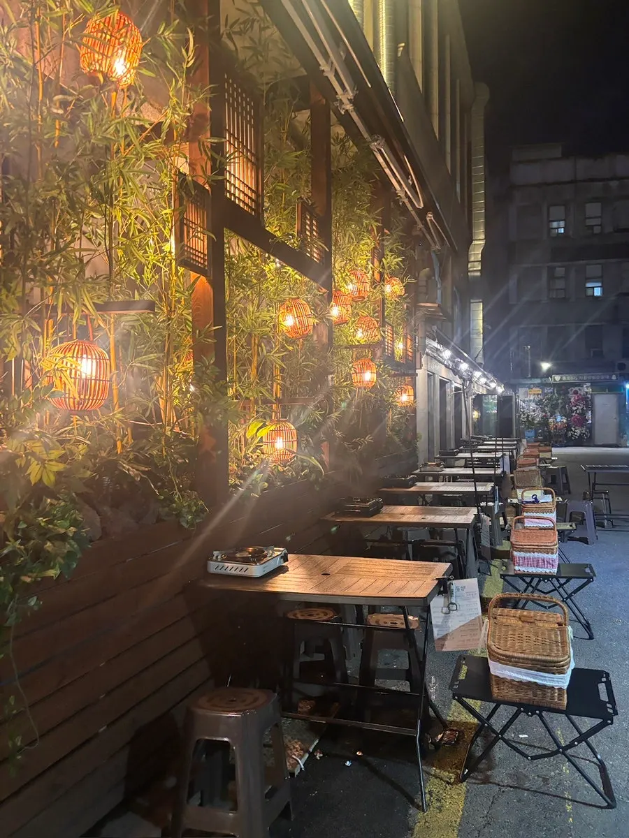 Outdoor tables full of guests in the Jongno 3-ga yajang street