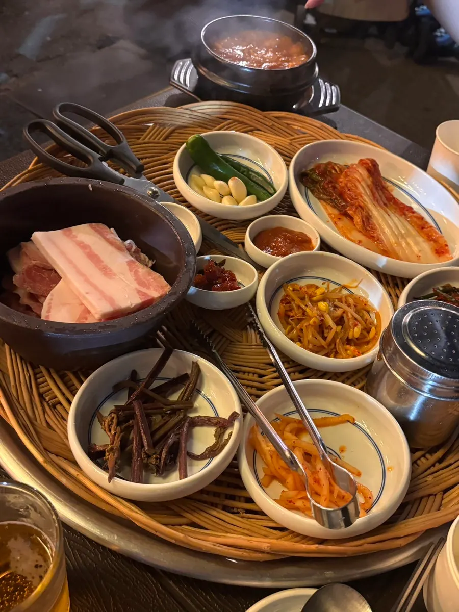 Side dishes including seasoned bean sprouts, bracken fern, and kimchi
