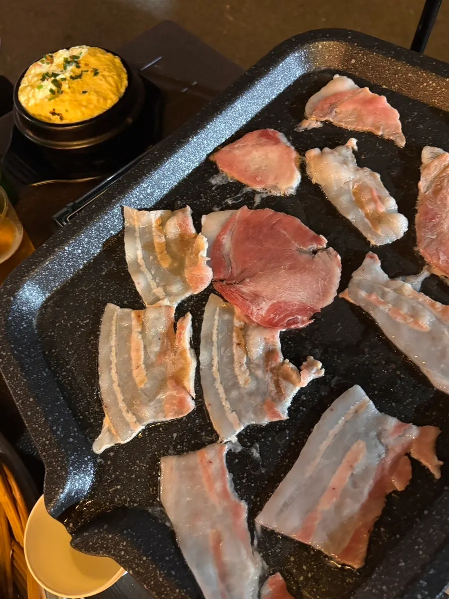 Close-up of golden-brown frozen pork belly on the grill