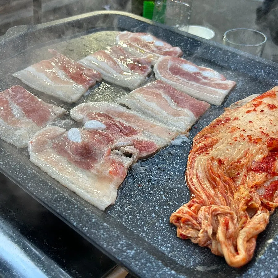 Thawed flash-frozen pork belly placed on the grill