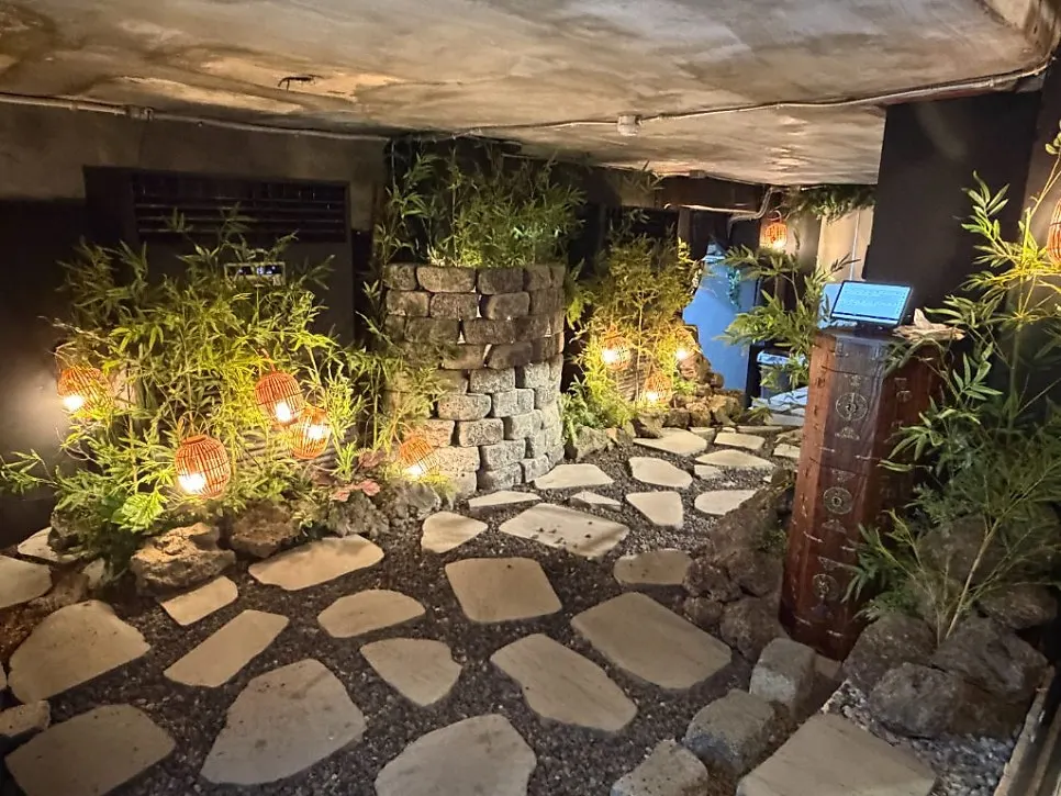 Outdoor dining area with a stone-path backdrop