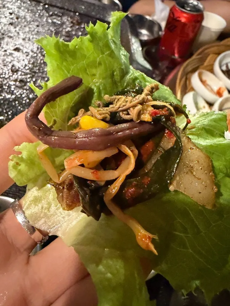 Pork belly ssam wrap filled with side dishes