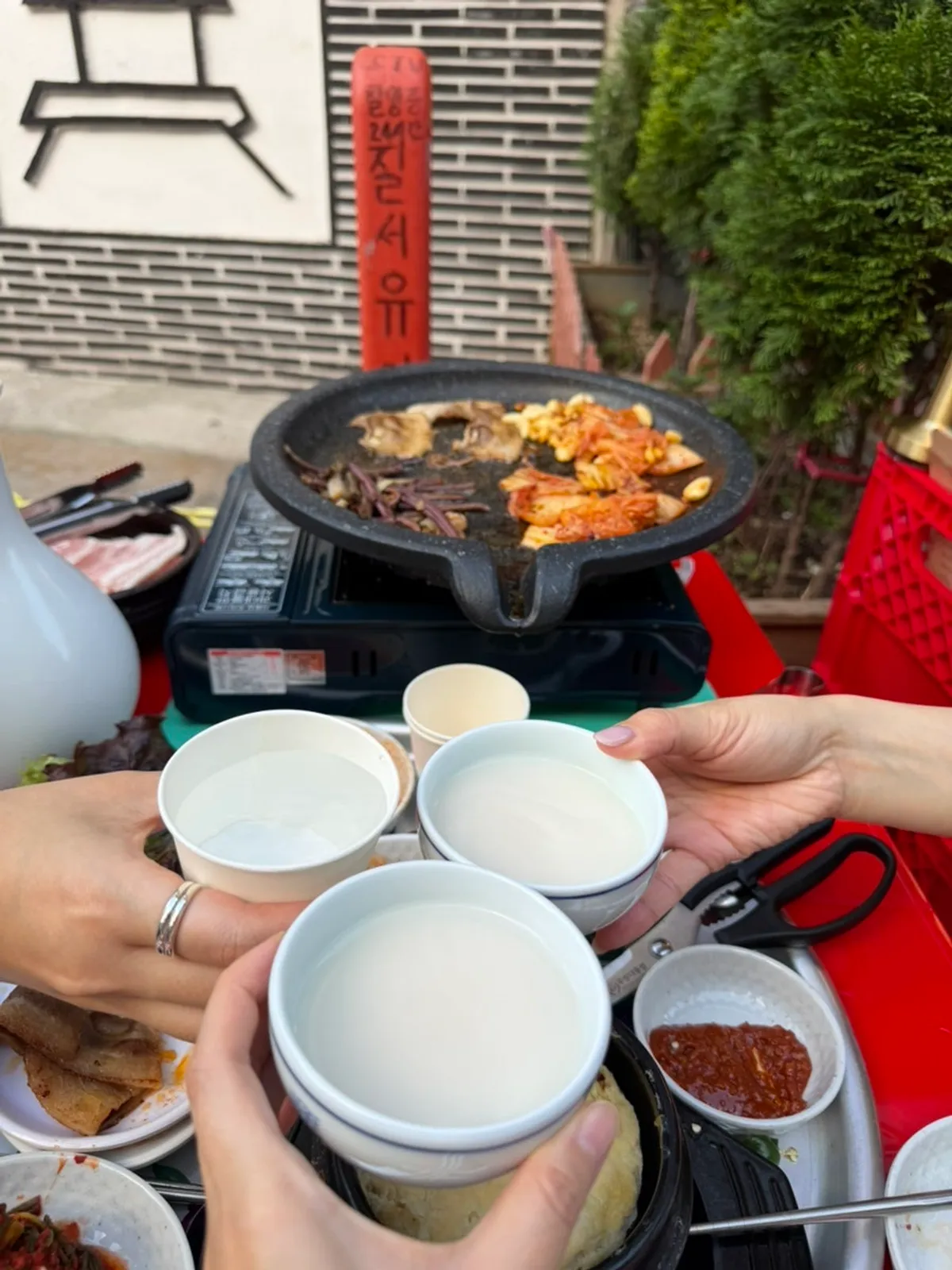 Frozen pork belly grilling at Chowon Restaurant's outdoor seats in the evening